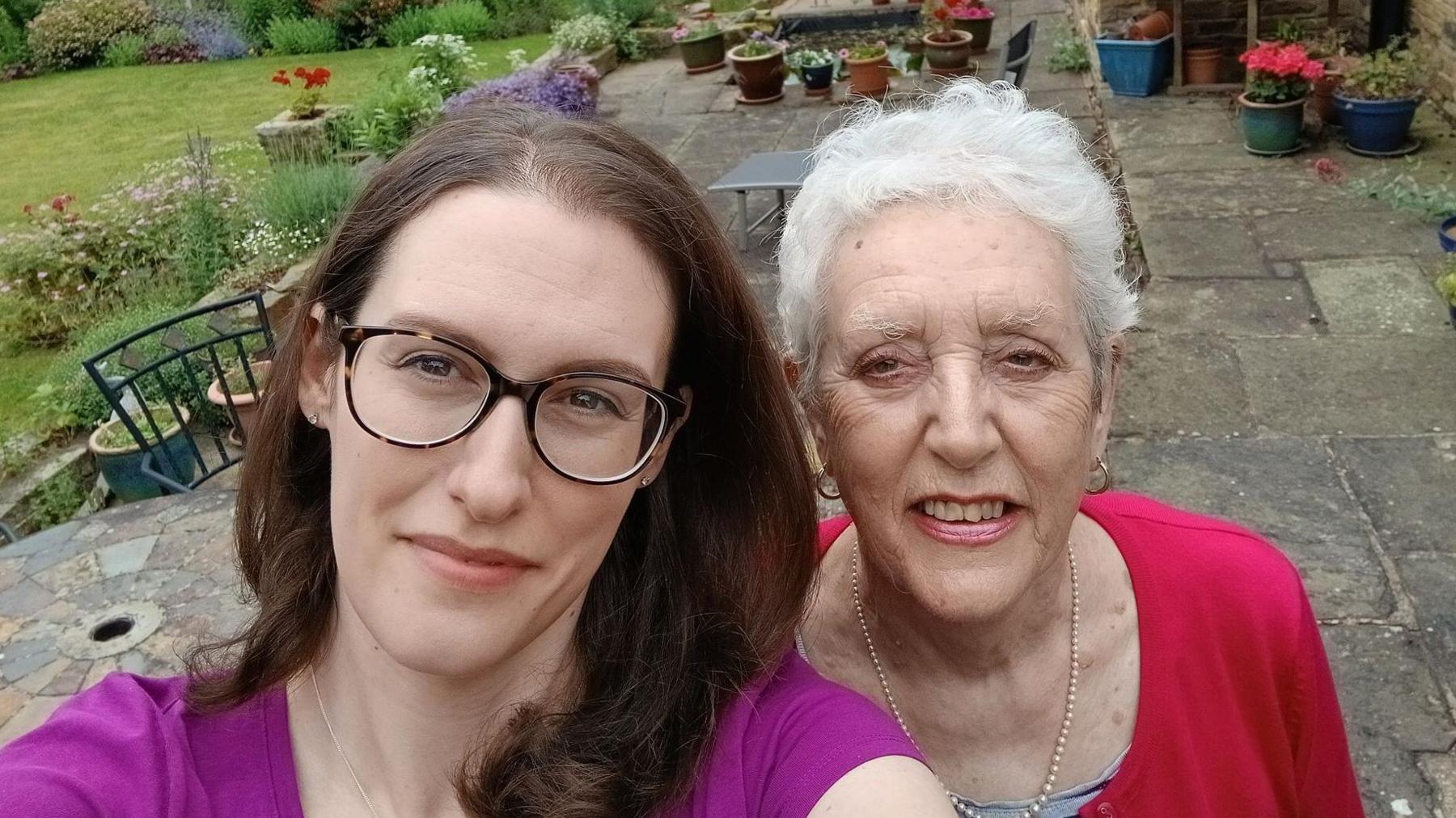 A selfie of Caroline Bentham and her mum Mary in a garden.