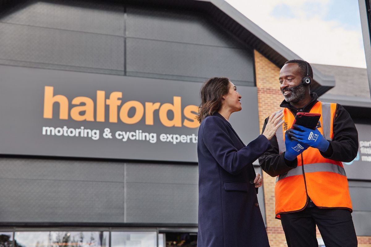 Halfords storefront with prominent signage, showcasing bicycles and automotive products, reflecting a bustling retail envi...