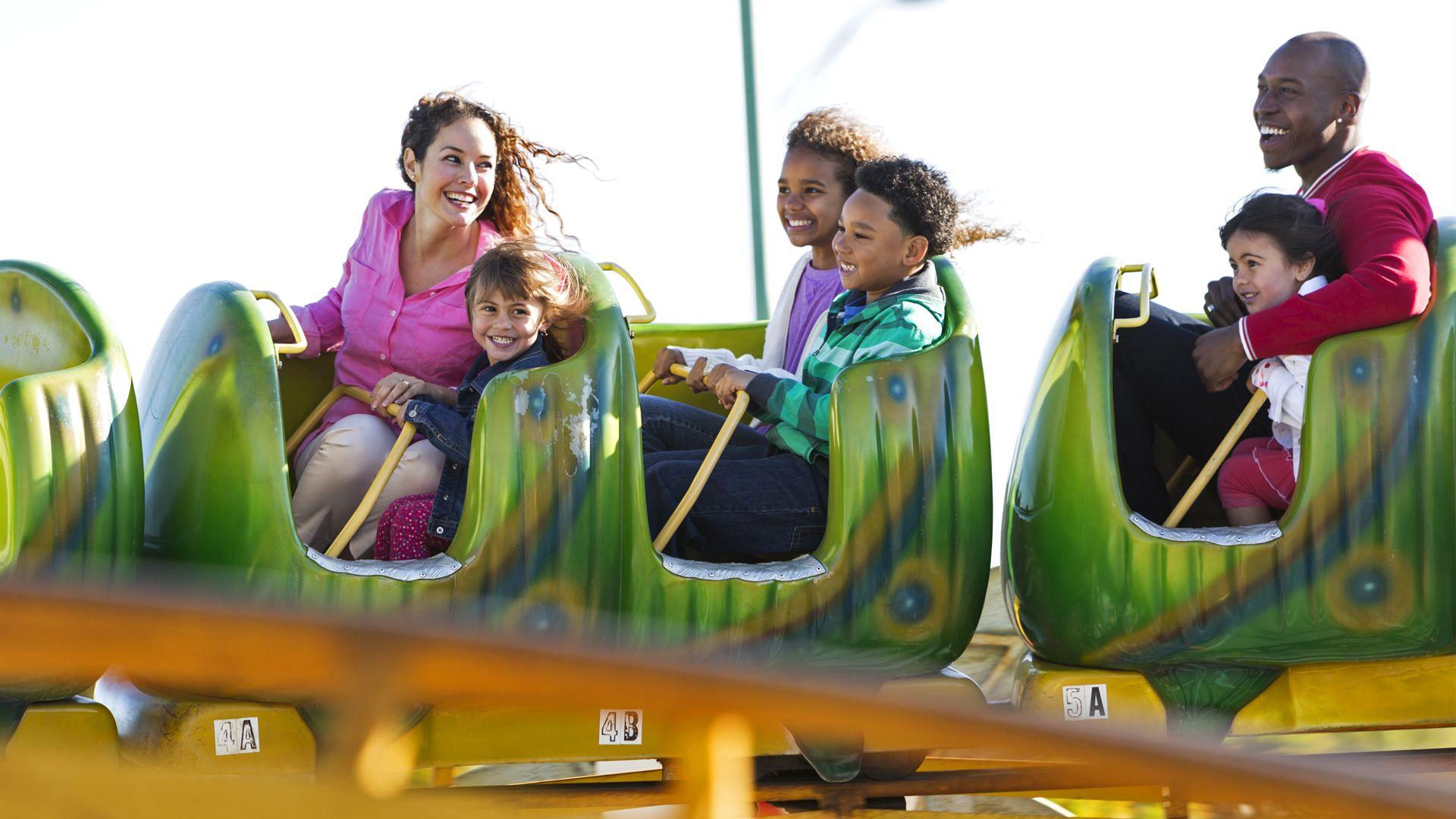 A stock image of a family enjoying a rollercoaster.