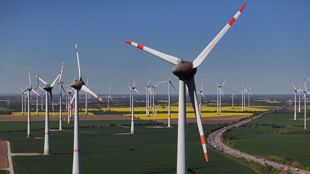 A German wind farm, with pylons spread out across flat fields