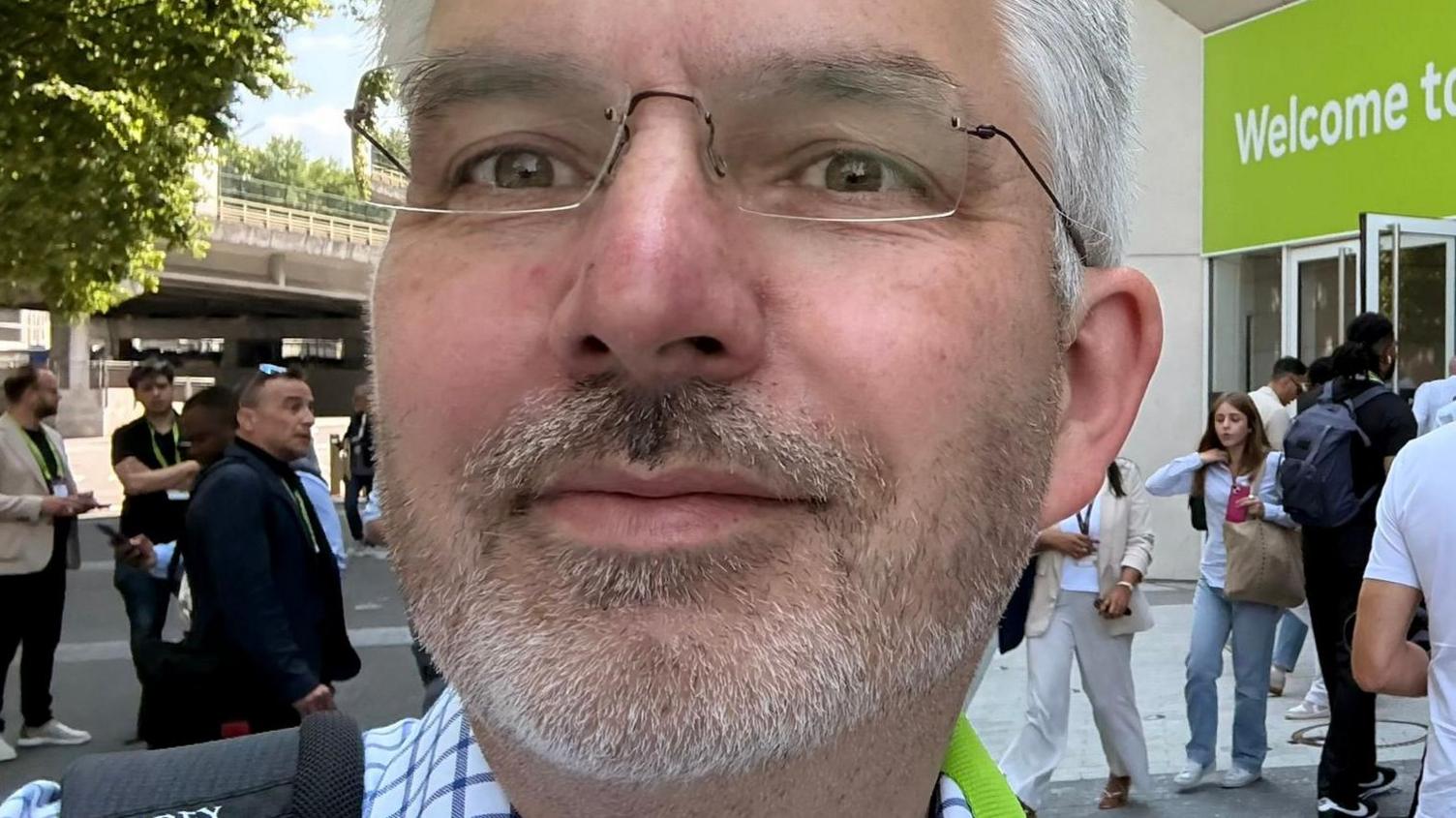 A close-up selfie of a man with white hair, a white beard and rimless glasses