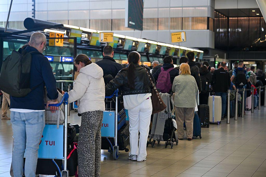 Crowds of passengers gathered at passport control areas at Amsterdam Airport Schiphol following the introduction of a new European digital border control system in Amsterdam, Netherlands on April 23, 2026.