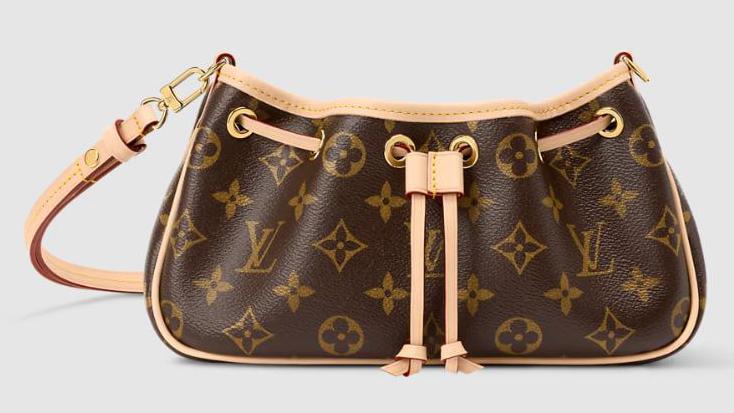 A brown Louis Vuitton handbag with the company's iconic graphics, including the four-petal flower monogram, printed across the leather