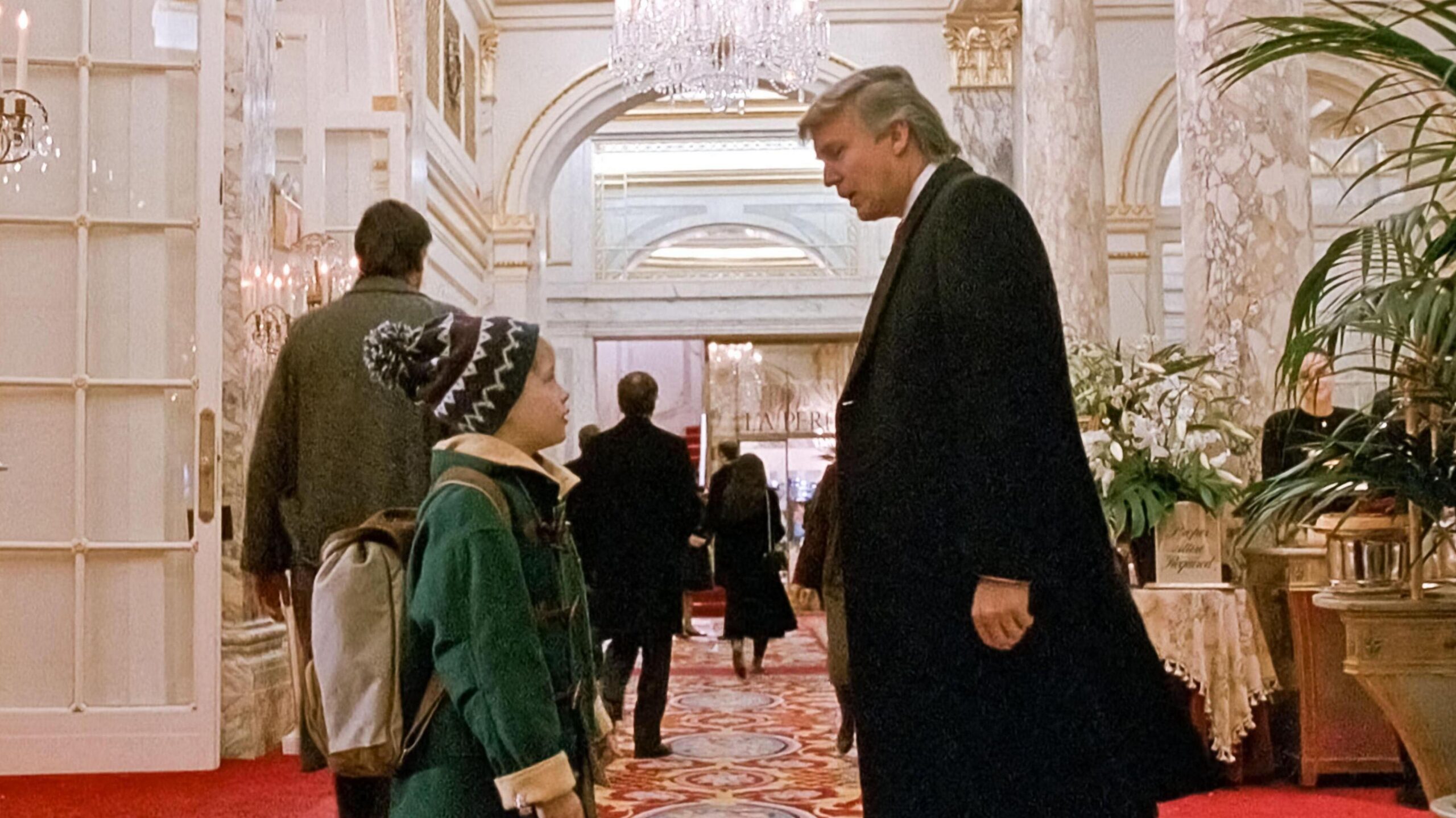 Screenshot from Home Alone 2, where Kevin, played by Macaulay Culkin, bumps into Donald Trump in the lobby of the Plaza Hotel