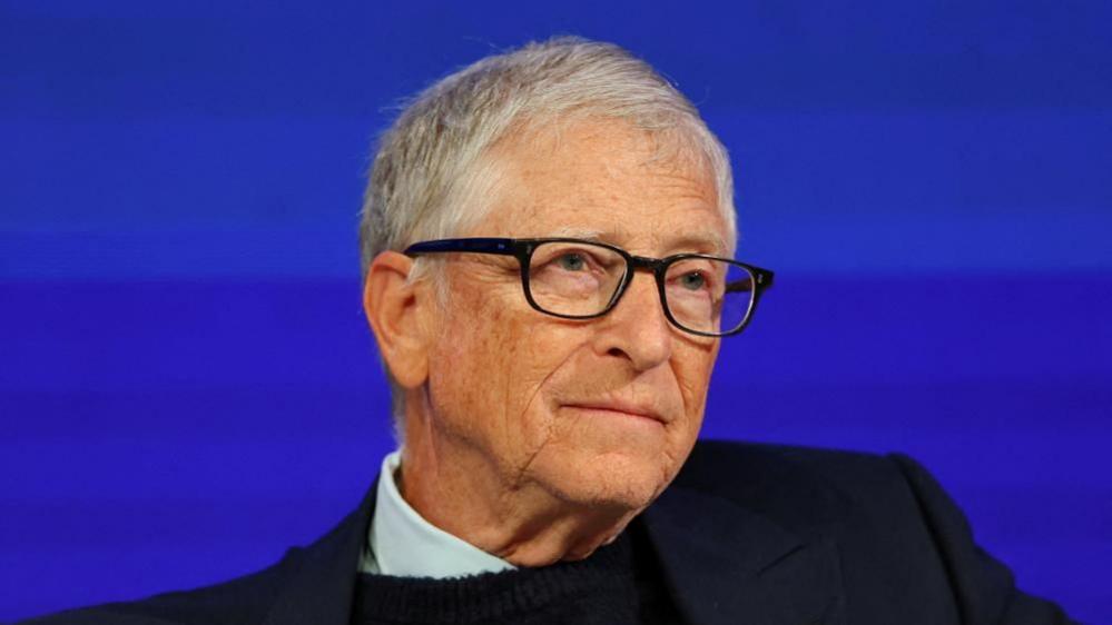 A file photo of Bill Gates - he is seated on stage at an event